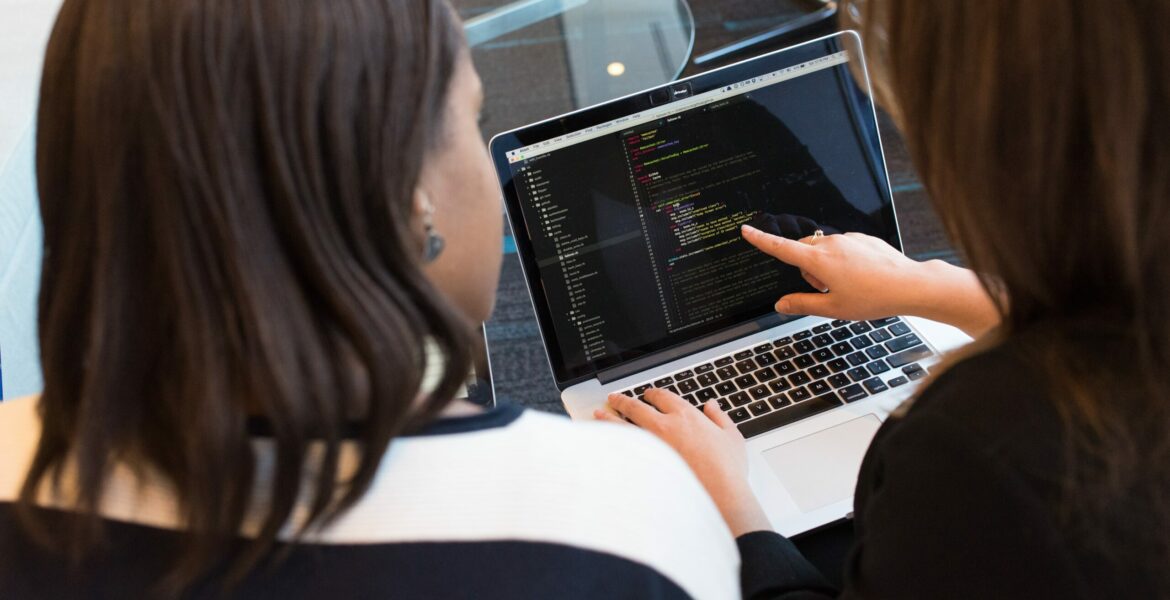 two-women-looking-at-the-code-at-laptop-1181263